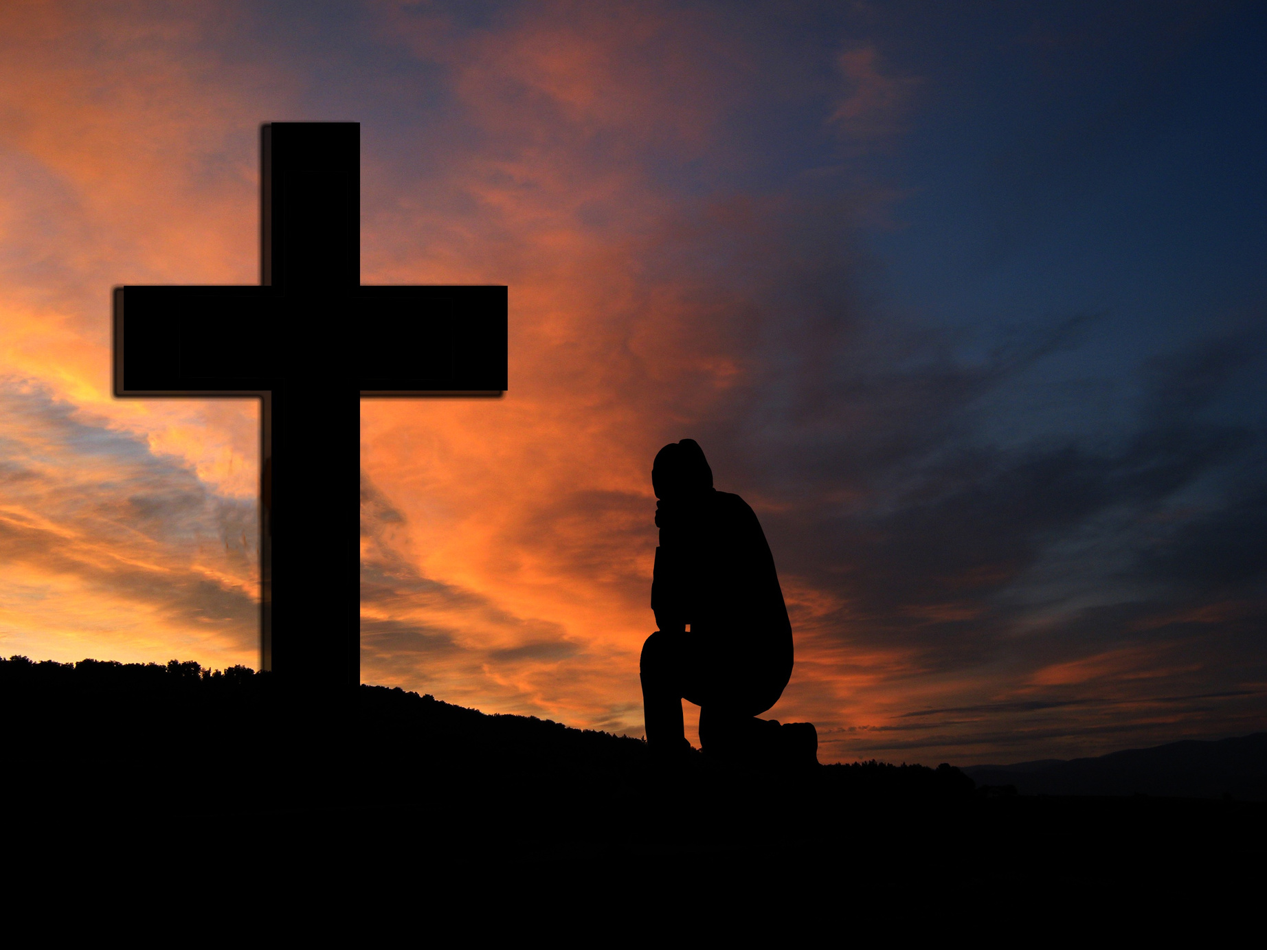 Man Kneeling in Front of a Cross